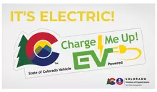 An image of an electric vehicle or EV parking space marking in green and white.